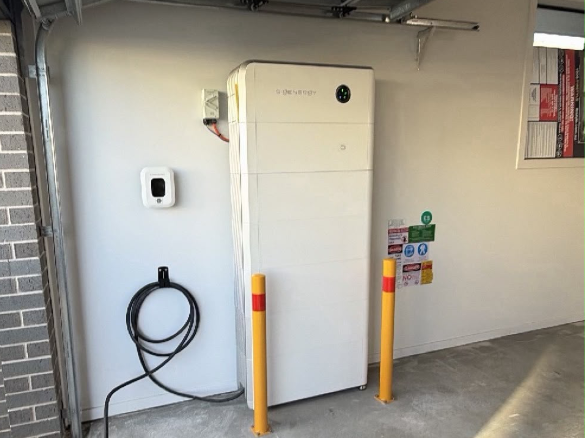 Home battery storage unit installed on the exterior wall of a residential property